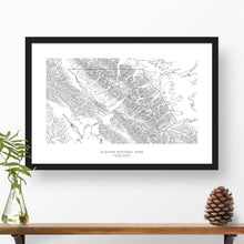 Load image into Gallery viewer, Framed travel art of Glacier National Park, featuring topography map art in black and white.