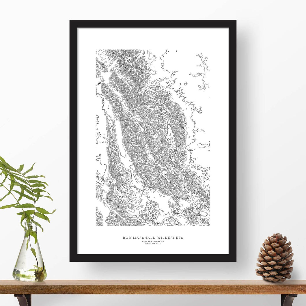 Black and white map and travel art of the Bob Marshall Wilderness. Topography contours are in black on a white background. Text below the image can be personalized for a perfect custom map art gift idea.