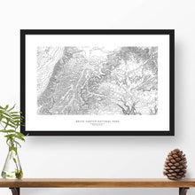 Load image into Gallery viewer, Map wall decor in a black frame. Contour lines of Bryce Canyon National Park are drawn on a white background. Text  below the map can be customized to create custom adventure art.
