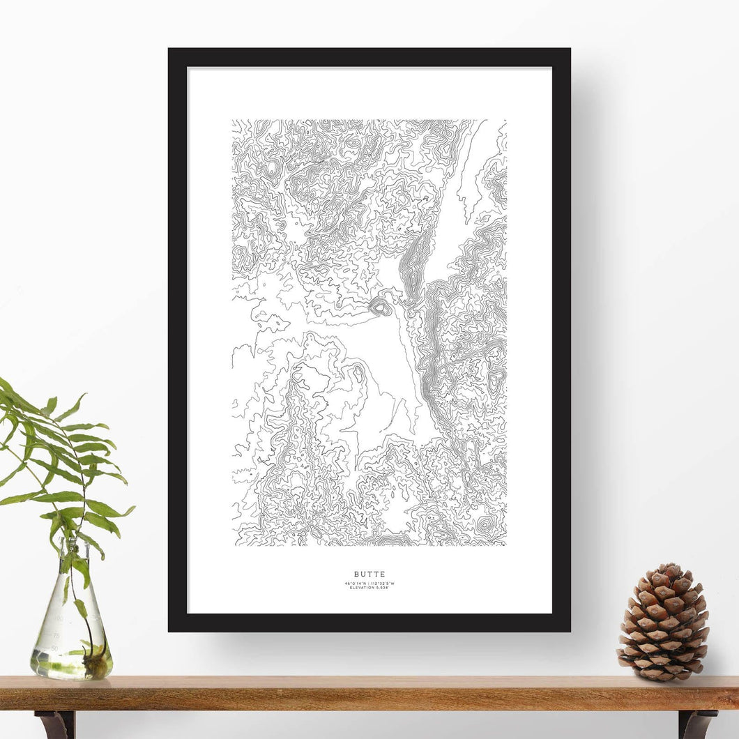 Print of Butte, Montana with black and white topography in a black 24x36 vertical frame.