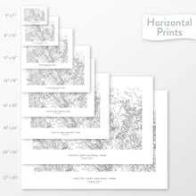 Load image into Gallery viewer, Available sizes for Capitol Reef National Park topographic maps. 5x7, 8x10, 11x14, 16x20, 18x24, 24x36, and 27x40 posters shown. as black and white prints on a gray background.
