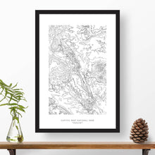 Load image into Gallery viewer, National park print of Capitol Reef with black and white topography in a black 24x36 vertical frame.
