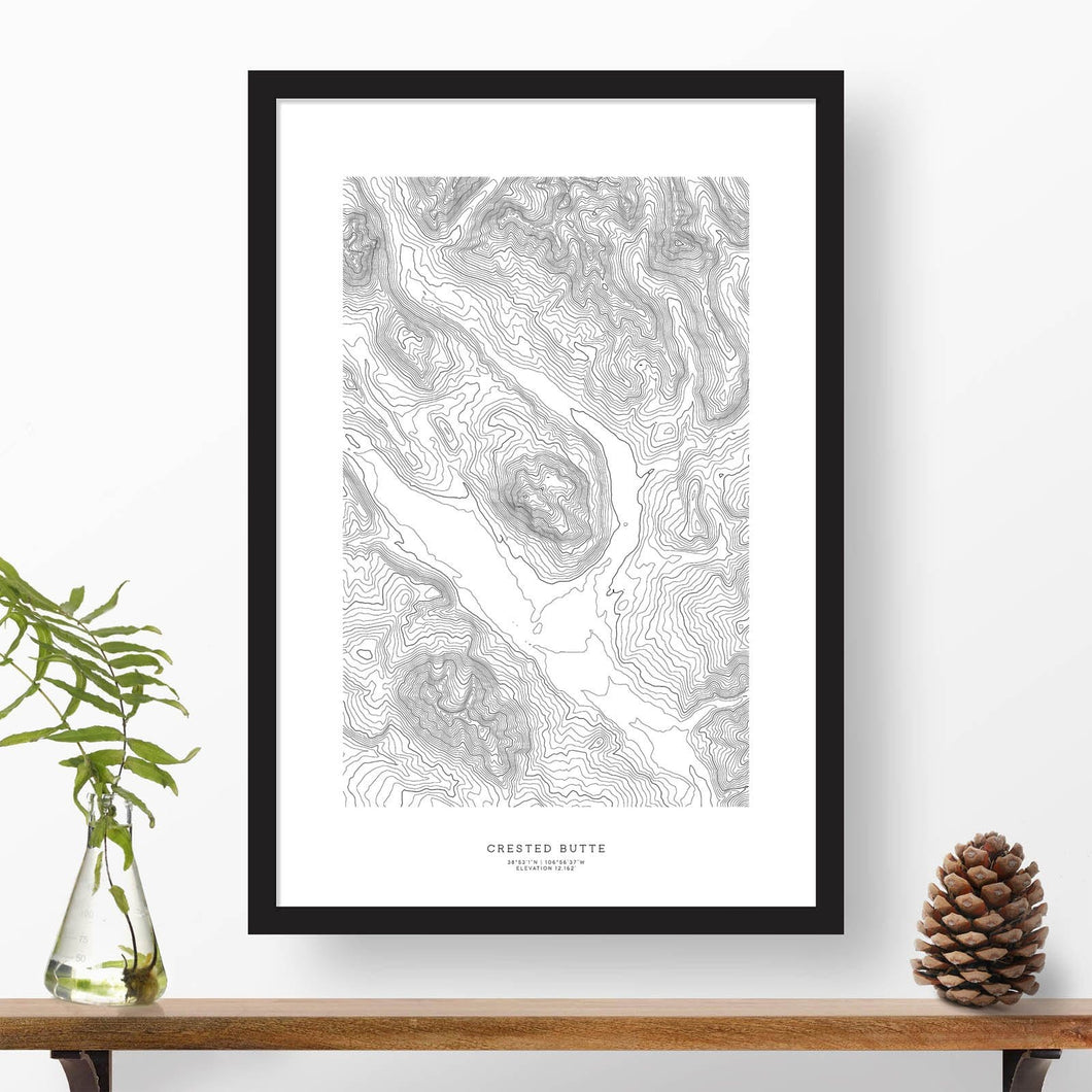 Black and white map and ski art of Crested Butte, Colorado. Topography contours are in black on a white background. Text below the image can be personalized for a perfect custom map art gift idea.