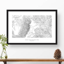 Load image into Gallery viewer, Framed black and white print of Grand Teton National Park topography art. Text can be added to create a custom map poster as a travel gift.
