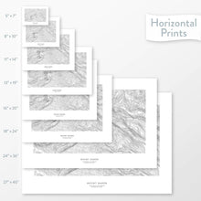 Load image into Gallery viewer, Available sizes for Mount Baker, Washington topographic maps. 5x7, 8x10, 11x14, 16x20, 18x24, 24x36, and 27x40 posters shown. as black and white prints on a gray background.
