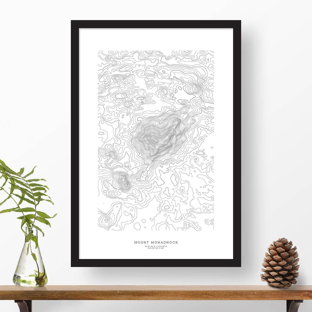 Black and white map and travel art of Mount Monadnock, New Hampshire. Topography contours are in black on a white background. Text below the image can be personalized for a perfect custom map art gift idea.