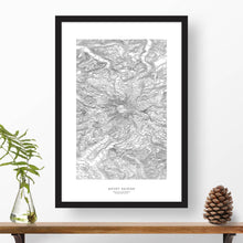 Load image into Gallery viewer, Mountain art print of Mount Rainier with black and white topography in a black 24x36 vertical frame.
