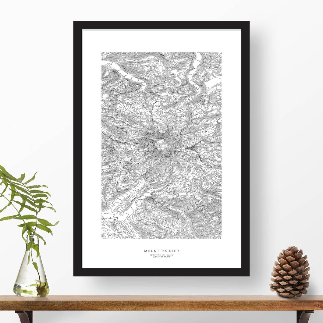 Mountain art print of Mount Rainier with black and white topography in a black 24x36 vertical frame.