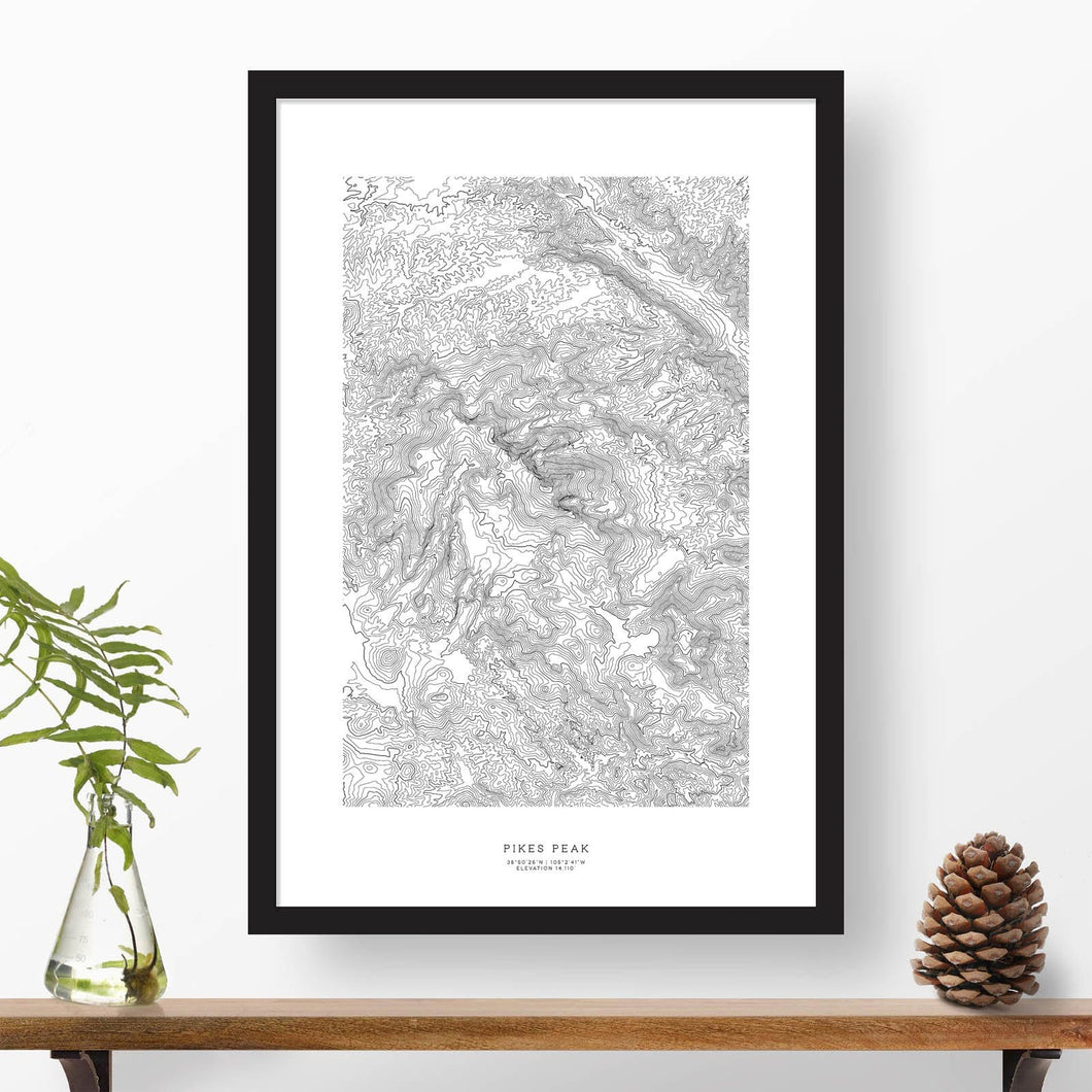 Black and white map and travel art of Pikes Peak, Colorado. Topography contours are in black on a white background. Text below the image can be personalized for a perfect custom map art gift idea.
