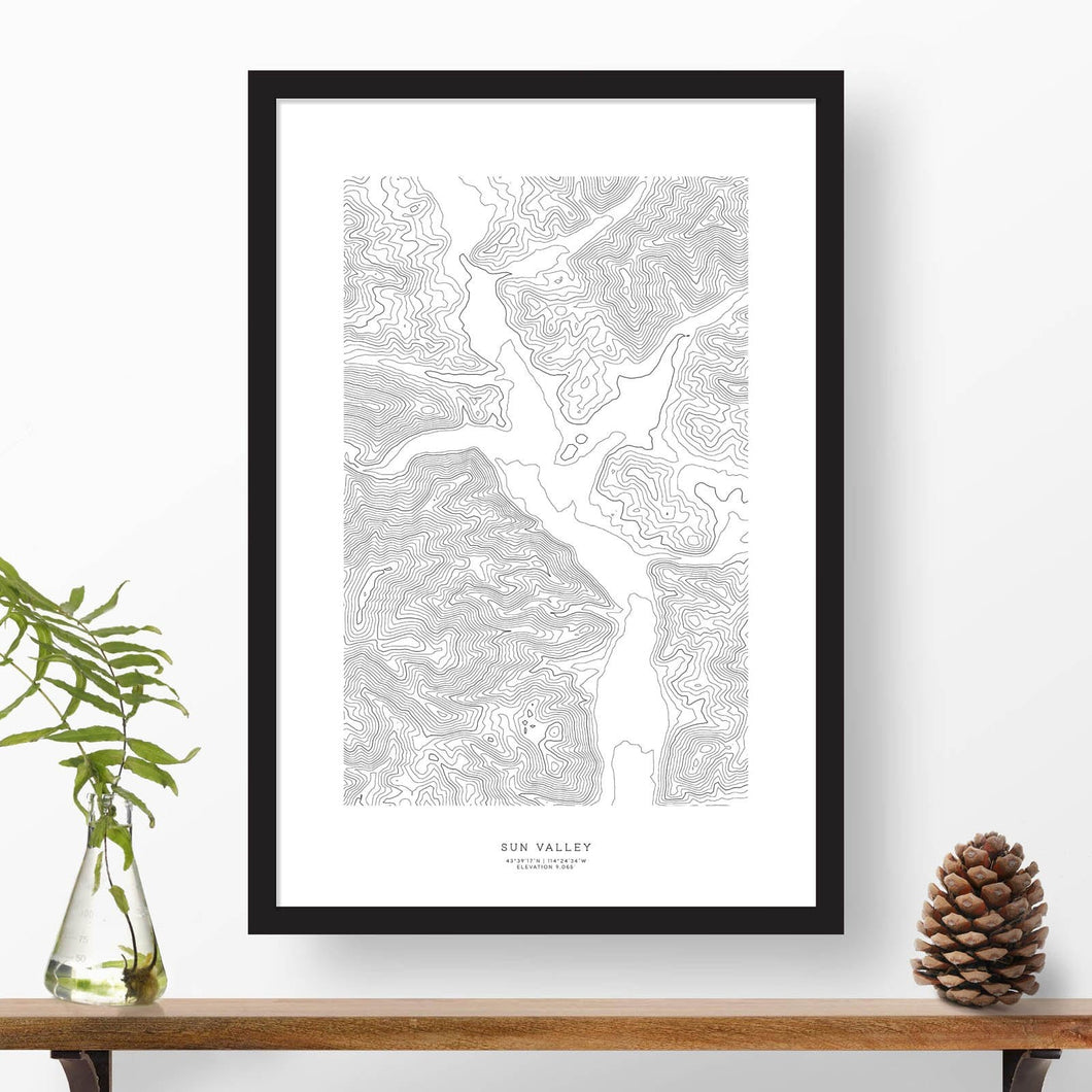 Black and white map and travel art of Sun Valley, Idaho. Topography contours are in black on a white background. Text below the image can be personalized for a perfect custom ski map art gift idea.