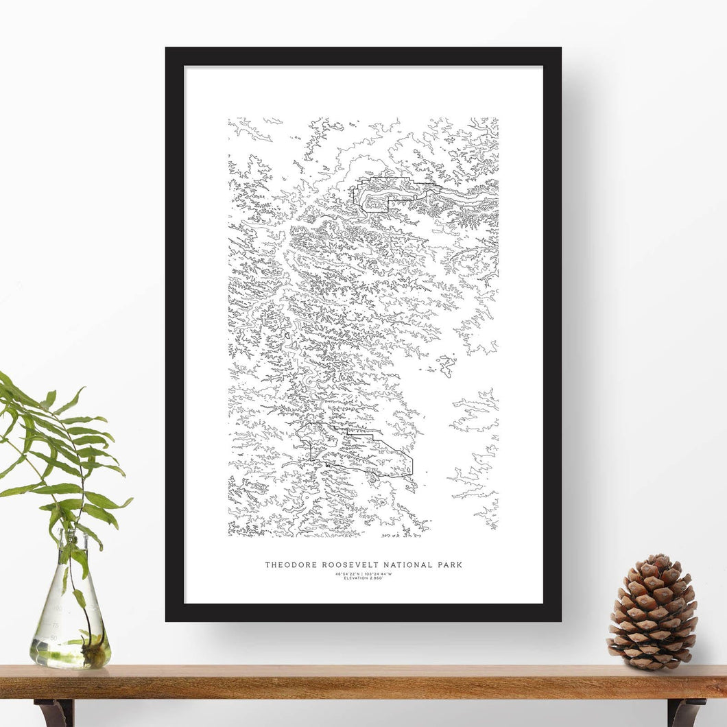Black and white map and travel art of Theodore Roosevelt National Park. Topography contours are in black on a white background. Text below the image can be personalized for a perfect custom map art gift idea.