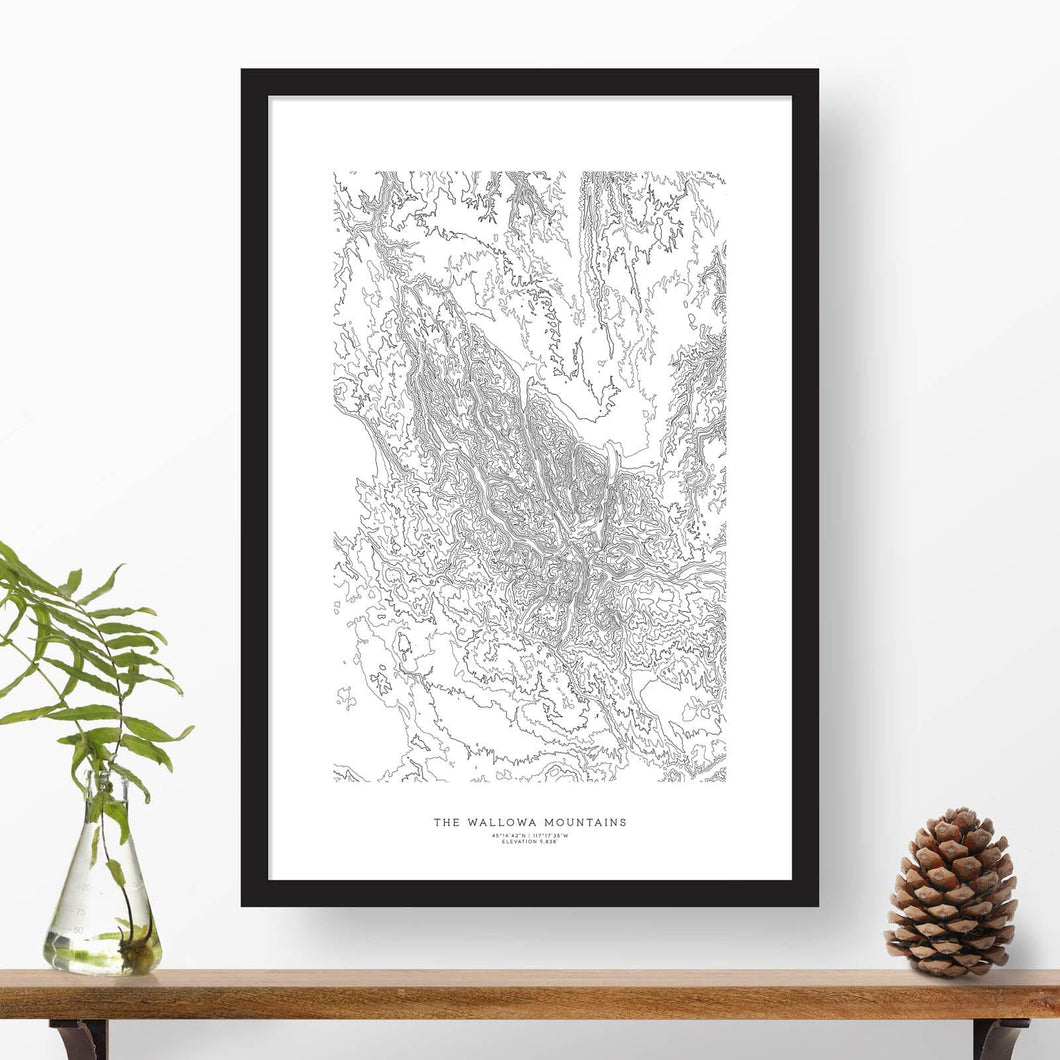 Black and white map and travel art of the Wallowa Mountains (the Wallowas). Topography contours are in black on a white background. Text below the image can be personalized for a perfect custom map art gift idea.