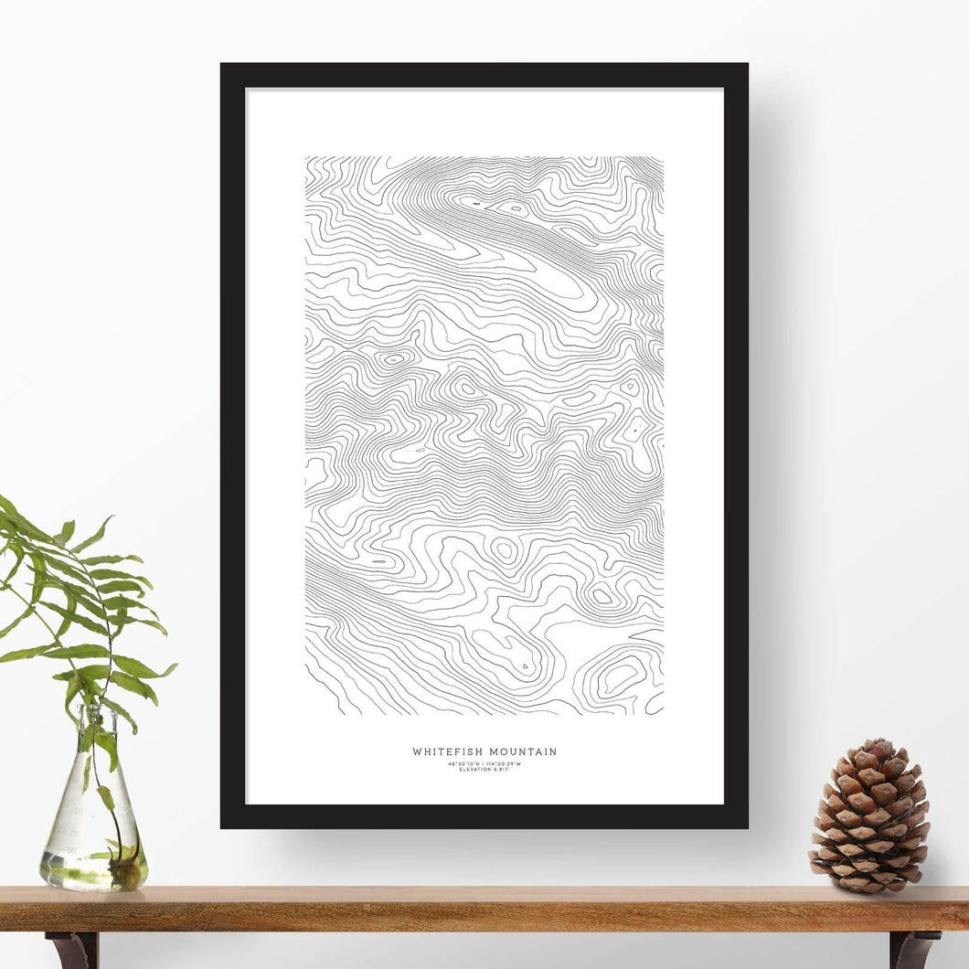 National park print of Whitefish Mountain, Montana with black and white topography in a black 24x36 vertical frame.
